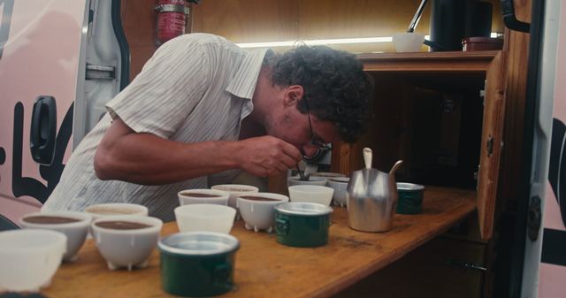 Cupping inside the van, rows of small bowls.